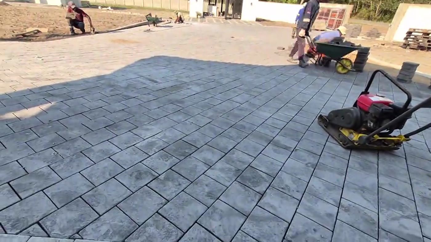 Brick paved driveway being compacted