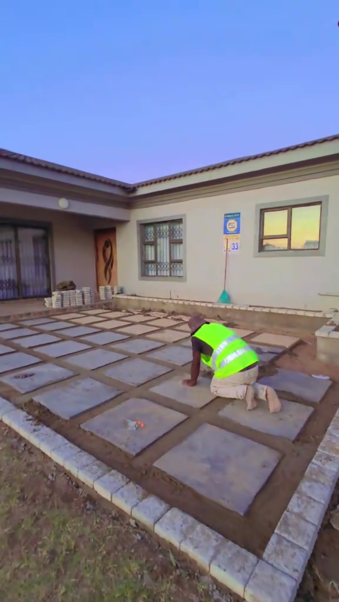 Large slab patio being laid outside a home