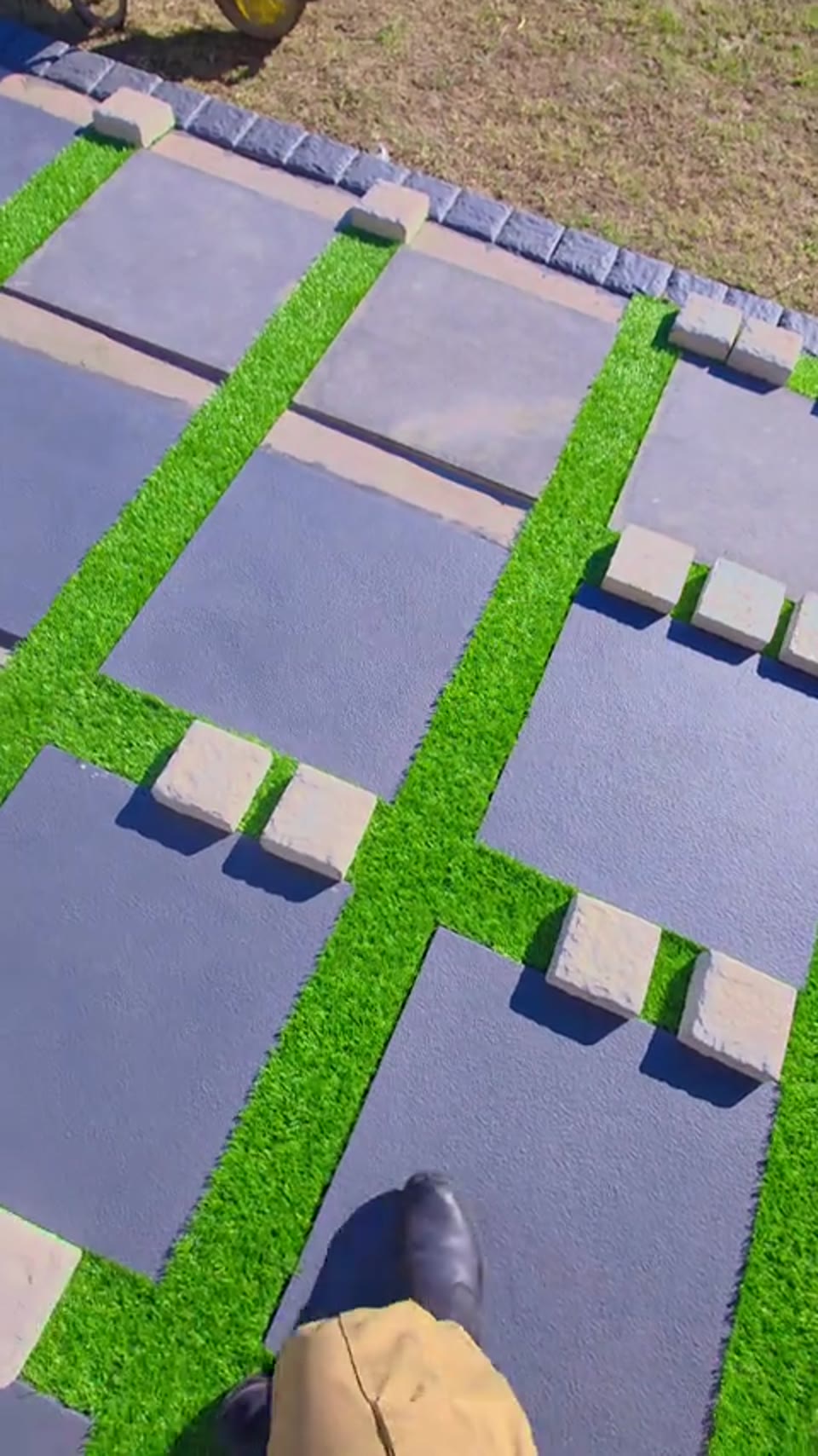 Concrete stepping slabs set into a green lawn